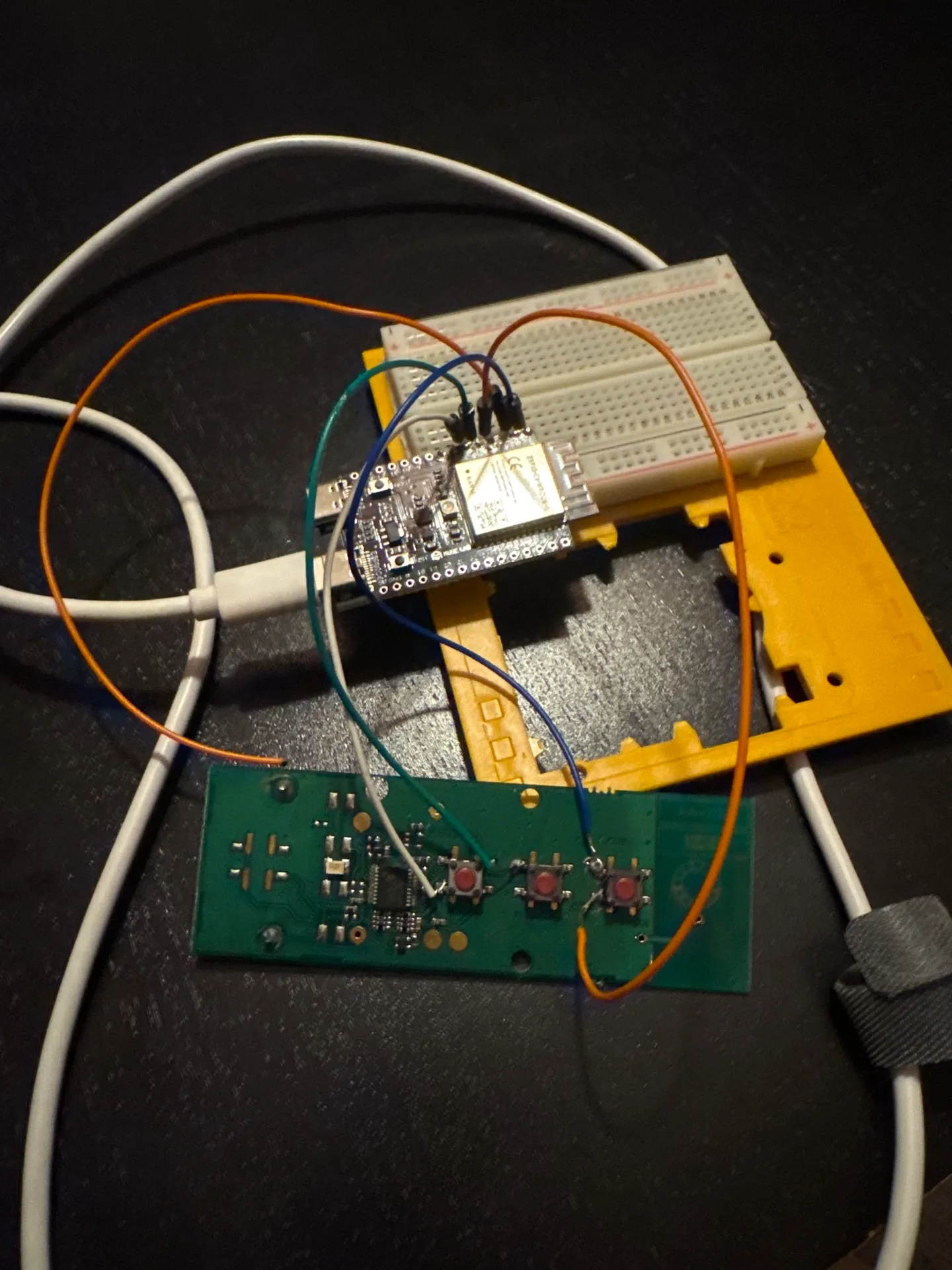 ESP32-C6 on a breadboard with four dupont wires soldered to the Telis PCB buttons